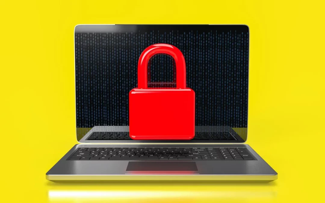 open laptop on yellow background with red lock on the display